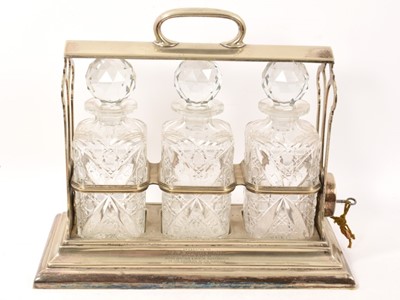 Lot 1060 - Silver plated three bottle tantalus