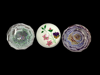 Lot 1158 - Three Whitefriars paperweights, including one titled 'Pansy', signed to base, and two faceted millefiori paperweights (one in box)