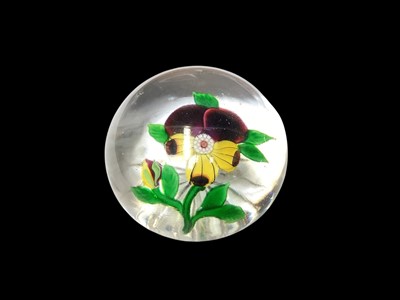 Lot 1165 - Baccarat paperweight decorated with a pansy, with star cut base