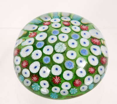 Lot 222 - 19th century French millefiori glass paperweight, with various coloured canes on a green ground