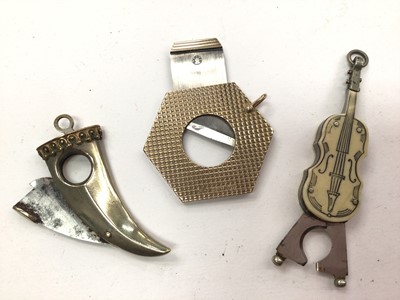 Lot 1057 - 1960s 9ct gold hexagonal cigar cutter with engine turned decoration and two further cigar cutters (3)