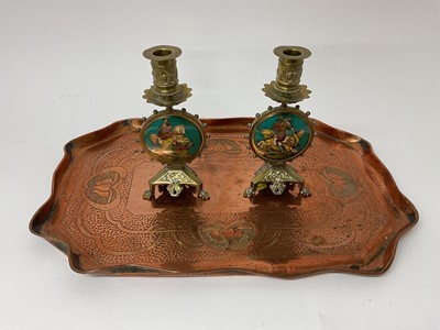 Lot 38 - Pair of Arts and Crafts style brass candlesticks with enamelled knights on horseback, together with an Arts & Crafts style copper tray (3)