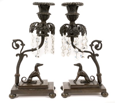 Lot 1083 - Pair of Regency bronze candlesticks with lustres and greyhound ornament