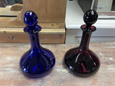 Lot 170 - Pair of cobalt blue/aubergine glass decanters and stoppers by Thomas Webb