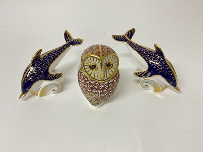 Lot 118 - Three Royal Crown Derby paperweights, including two dolphins and an owl