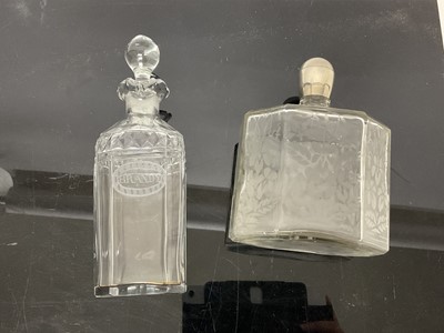 Lot 362 - Georgian cut glass decanter with etched 'Brandy' label, and an antique continental octagonal bottle with etched floral decoration (2)