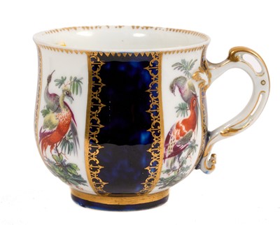 Lot 231 - A Chelsea cabinet cup, c.1760-65, finely decorated with panels of colourful birds perched in branches, alternating with mazarine blue panels with gilt trellis, gold anchor mark,...