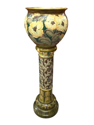 Lot 202 - Burmantofts faience jardinière and stand, with tube-lined flowers in yellow, green and brown, impressed marks, the stand 89cm high and the jardiniere 34.5cm high x 37cm diameter