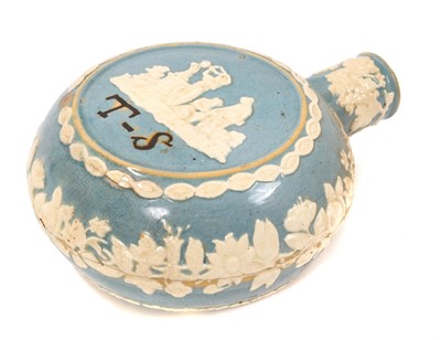 Lot 35 - Unusual 19th century pottery flask, decorated in relief with figural scenes and flowers, inscribed with the initials 'TS', on a blue-glazed ground, 17.5cm high