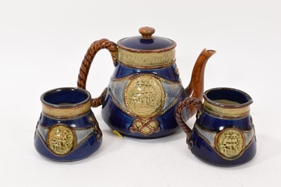 Lot 212 - Royal Doulton three-piece tea set, comprising teapot, sugar bowl and cream jug, each decorated with an inscribed portrait of Lord Nelson, with banded motto above, impressed marks, the teapot 13....