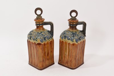 Lot 213 - Pair of Doulton Lambeth flagons retailed by G.W. Scott & Sons, with grapevine decoration, with one stopper inscribed 'Brandy' and the other 'Scotch Whisky', 25cm high