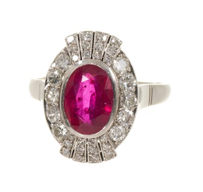 Lot 624 - Art Deco style ruby and diamond cluster cocktail ring with an oval mixed cut ruby estimated to weigh approximately 3.25cts, surrounded by ten brilliant cut diamonds estimated to weigh approximat...