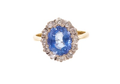 Lot 685 - Sapphire and diamond cluster ring with an oval cornflower blue sapphire