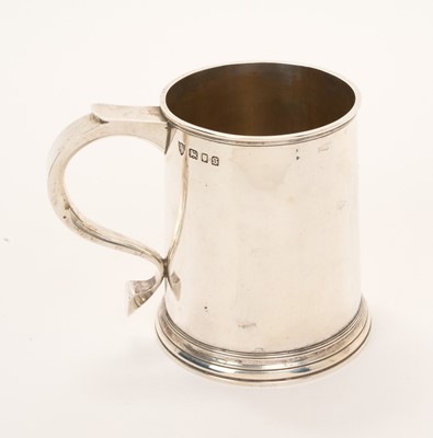 Lot 537 - George V silver tankard of tapered cylindrical form with scroll handle, (London 1933)