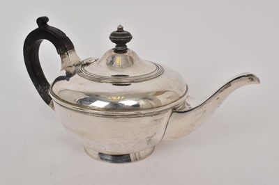 Lot 533 - Victorian Irish silver teapot of cauldron form with ebony finial and handle, raised on circular foot