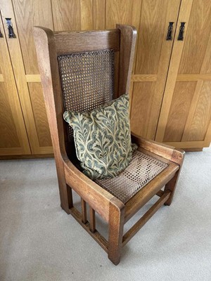 Lot 1623 - Liberty style caned oak high back chair raised on castors