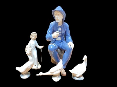 Lot 1197 - Impressive Nao figure - Fisherman smoking a pipe, together with three Nao geese and another figure (5)