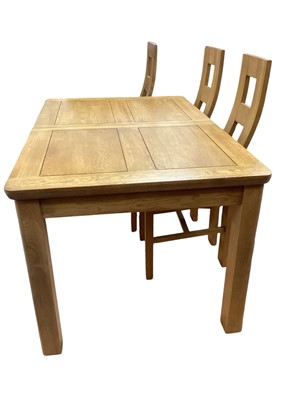 Lot 1202 - Contemporary light oak dining table with extra leaf, 140cm x 90cm, together with a matching set of six chairs