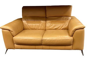 Lot 1207 - Contemporary tan leather two seater sofa with reclining headrests, 160cm wide