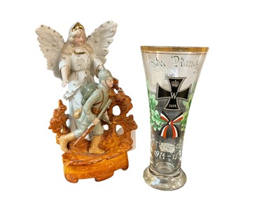 Lot 923 - First World War Imperial German drinking glass with enamel painted Iron Cross decoration, together with a military themed porcelain figure group (2)