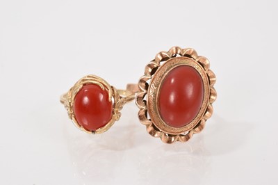 Lot 74 - Two gold mounted polished oval coral dress rings