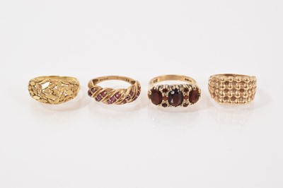 Lot 76 - 18ct gold bombé ring with leaf decoration, 9ct gold ruby set bombé ring, Victorian style 9ct gold garnet ring and a 9ct gold textured signet ring (4)