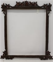 Lot 1564 - A 19th century Black Forest carved wood frame...