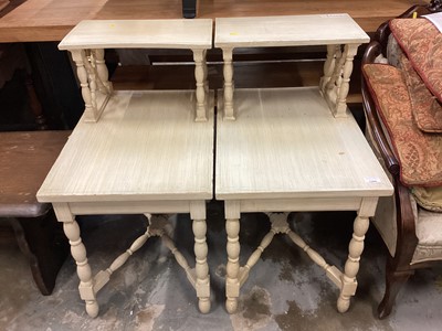 Lot 1306 - A pair of cream painted two tier bedside tables