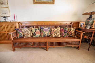 Lot 1635 - Liberty style settle, with moorish lattice back and frieze and solid seat, 227cm long