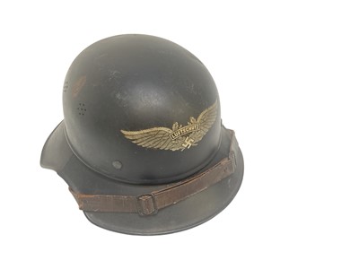 Lot 732 - Second World War Nazi Luftschutz helmet with original paint, transfer badge, with later lining.