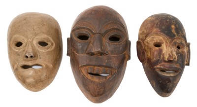 Lot 1085 - Group of three early 20th century carved wooden masks.