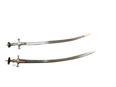 Lot 1023 - Two 19th century Indian Tulwars, the blades approx. 85 and 82cm in length respectively.