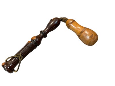 Lot 939 - 19th century lignum vitae life preserver with ribbed grip and bulbous head suspended from leather strap, 38.5cm in length.