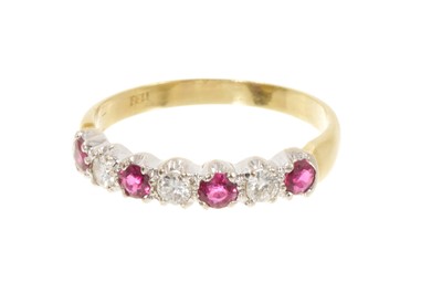 Lot 665 - Ruby and diamond eternity ring in 18ct gold