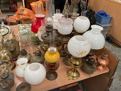 Lot 437 - Group of brass oil lamps, together with shades, burners and chimneys.