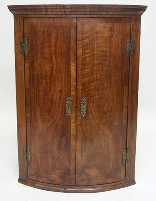 Lot 1658 - George I walnut bowfront corner cupboard