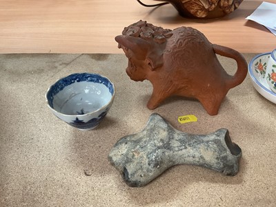 Lot 107 - Neolithic stone hand tool, a ceramic model of a bull, and an 18th century Chinese blue and white tea bowl (3)