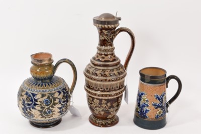 Lot 259 - Doulton Lambeth stoneware ewer decorated by Louisa J. Davies, with silver rim, and two other Doulton jugs with silver rims, the largest 28.5cm high