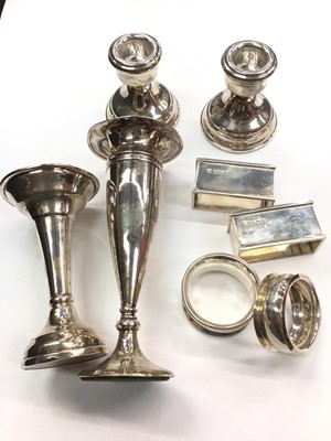 Lot 1041 - Pair of silver squat candlesticks, two silver spill vases and four silver napkin rings