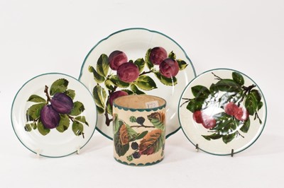 Lot 269 - Three Wemyss pottery plates decorated with plums and cherries, and a Wemyss pot decorated with blackberries (4)