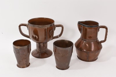 Lot 272 - Four pieces of Doulton 'Silicon' pottery imitating riveted copper ware, including a goblet, jug, and two tumblers (4)