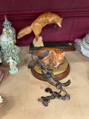 Lot 708 - Two carved burr wood models of forces, and a cast model of a fox (3)