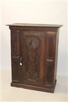 Lot 1735 - Unusual carved oak enClockssed cupboard with...