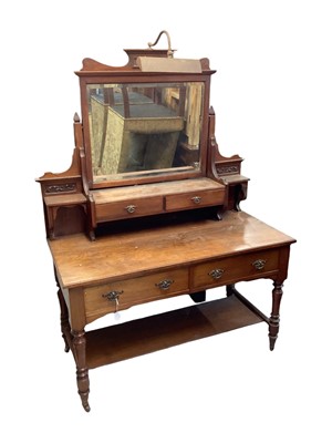 Lot 1409 - Edwardian walnut dressing table with raised bevelled mirror back, bearing label Maple & Co