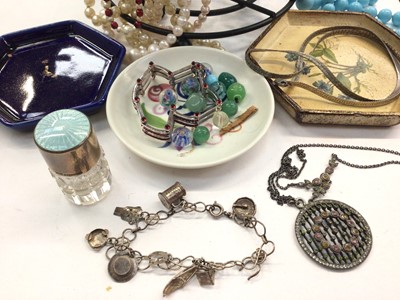 Lot 1076 - Group of costume bead necklaces on stand, sterling silver paste set pendant necklace, white metal charm bracelet, silver and enamelled glass perfume bottle and bijouterie