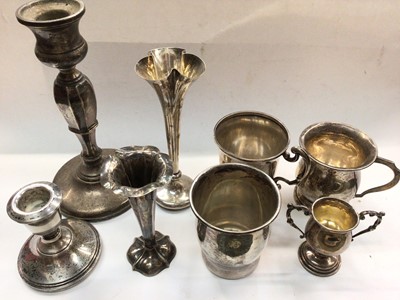 Lot 1100 - Group of silver to include candlesticks, spill vases, miniature trophy, two christening mugs and a white metal cup