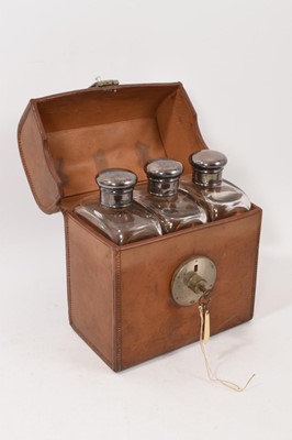 Lot 1098 - Trio of Edwardian silver topped glass flasks in leather fitted case