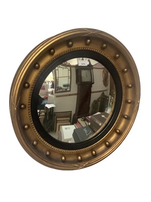 Lot 1470 - Convex wall mirror in gilt frame with ball decoration, 60cm diameter