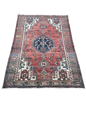 Lot 1502 - Eastern rug with geometric decoration on red, blue and cream ground, 188cm x 122cm