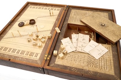 Lot 1095 - Rare boxed musical game, patented by Ann Young, 1801, with folding mahogany case, opening to reveal paper lined playing surface, with end drawers and well enclosing various engraved ivory dice,...